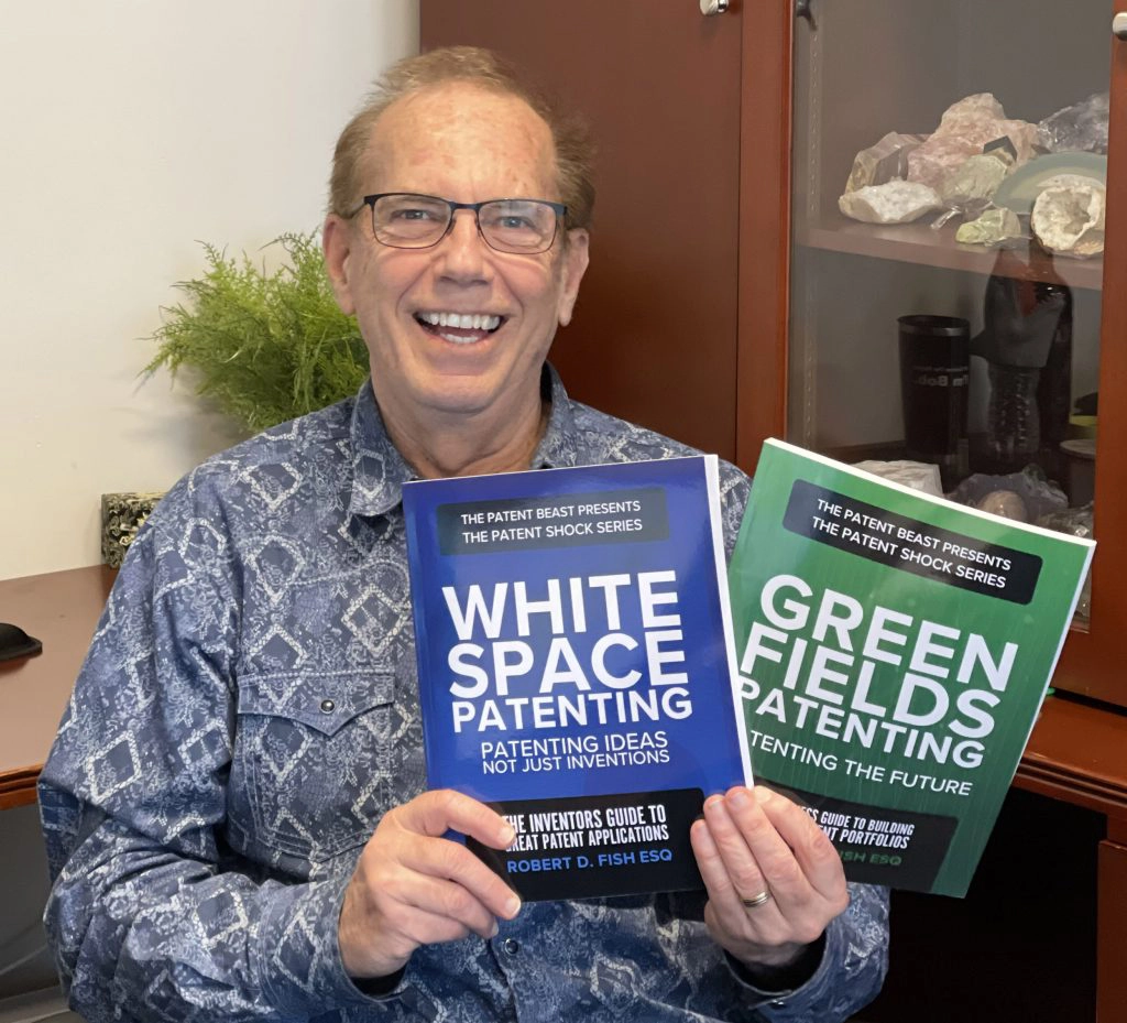Bob Fish holding copies of his updated books: White Space Patenting and Green Fields Patenting.